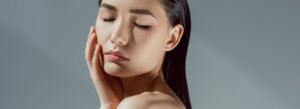 model with eyes closed and hand to face