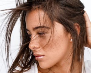 model with hair over face