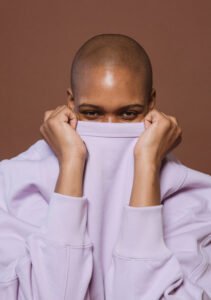 model covering half her face