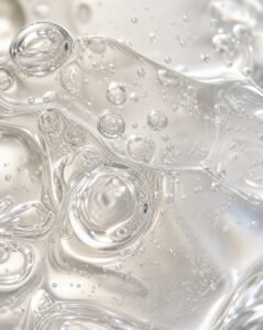 Ahigh-end macro texture shot of a clear, fluid skincare thick gel illustrating how biomimetic lipids breathe with your skin.